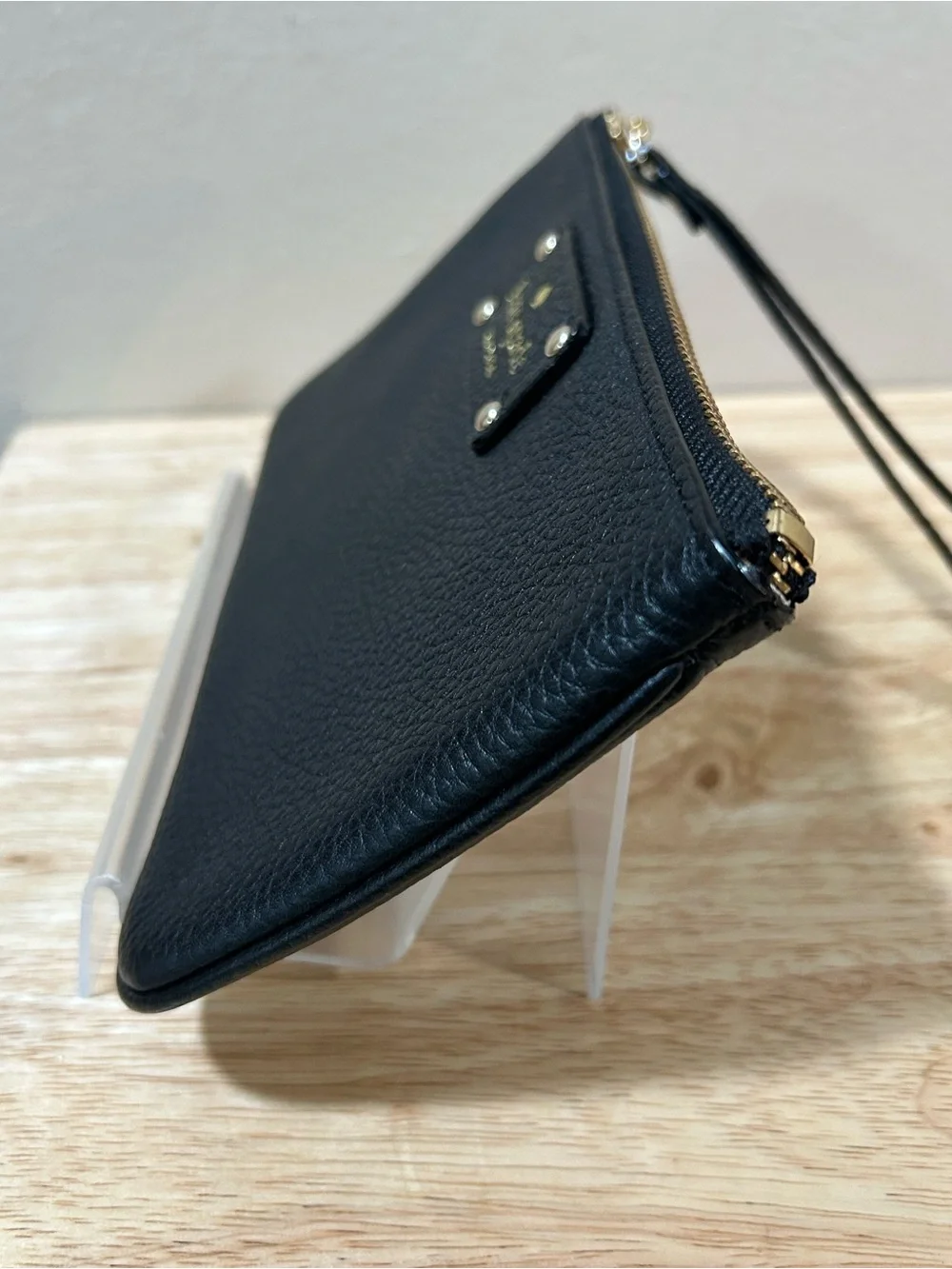 kate spade black pebbled leather wristlet with gold-tone logo